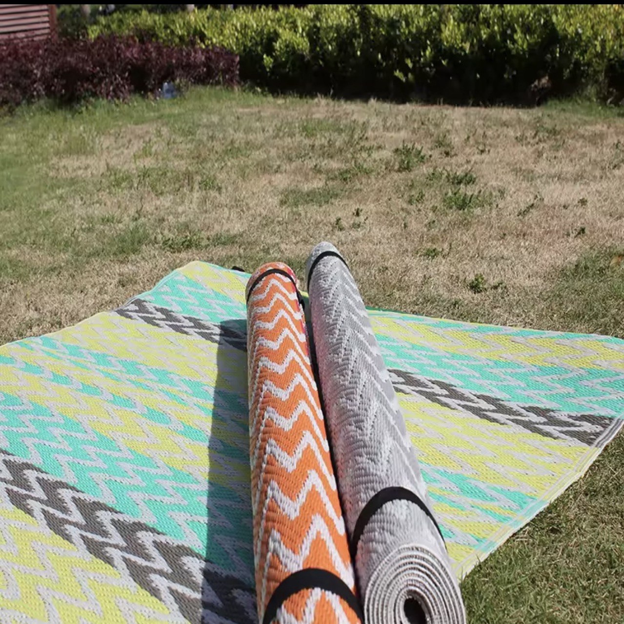 Rolled PP plastic mats outdoors on grass