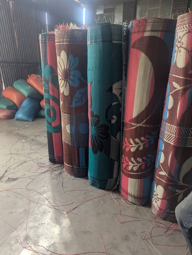 Rolled patterned PP plastic mats standing upright