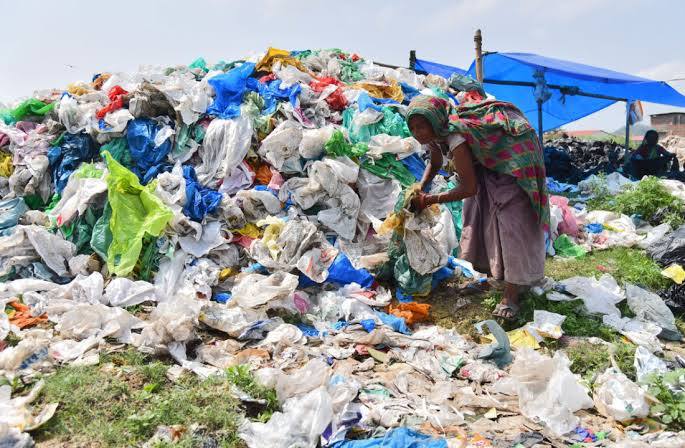 Worker sorting plastic waste by hand